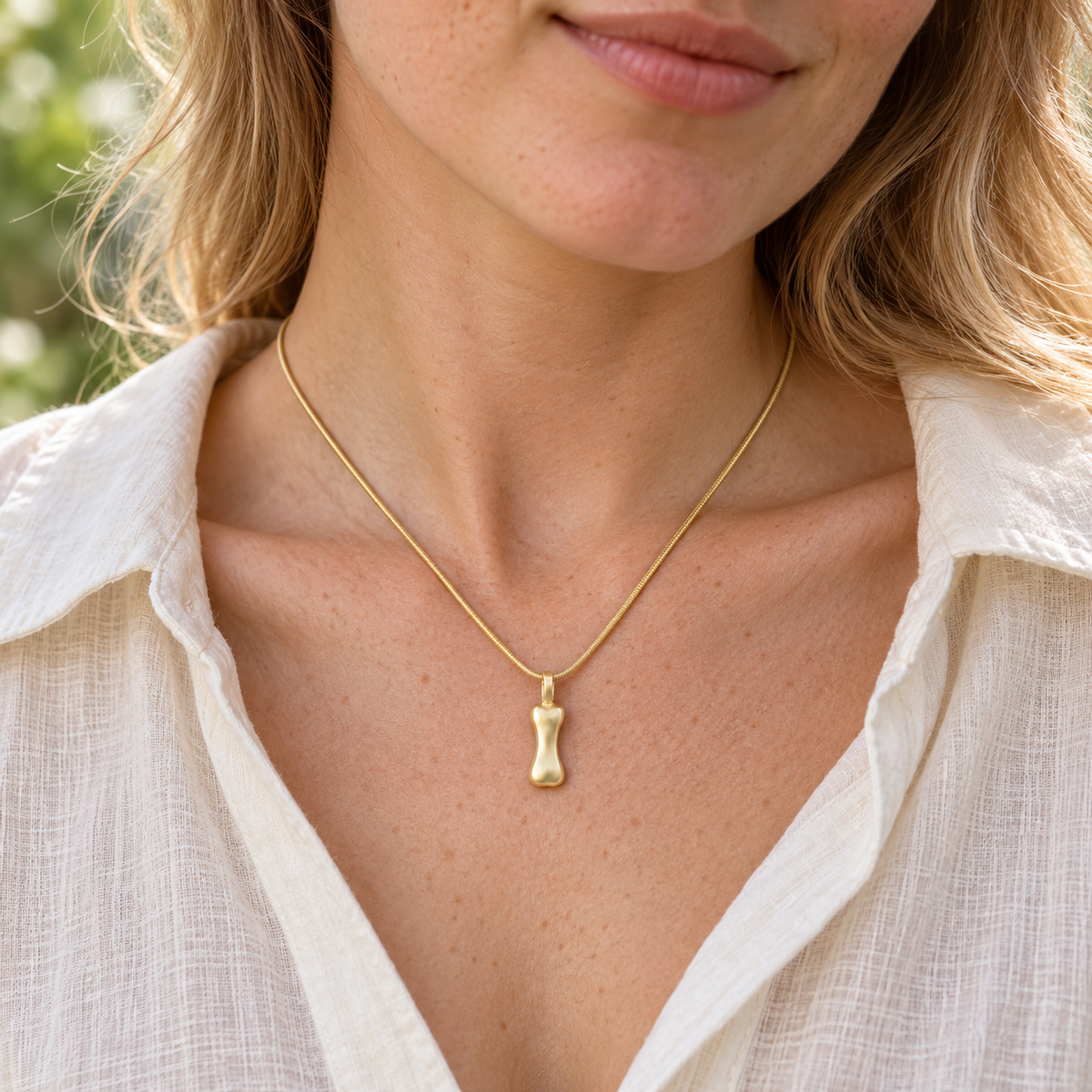Gold Plated Over Sterling Best Pal Bone Permanently Sealed Waterproof Jewelry worn on an adult model