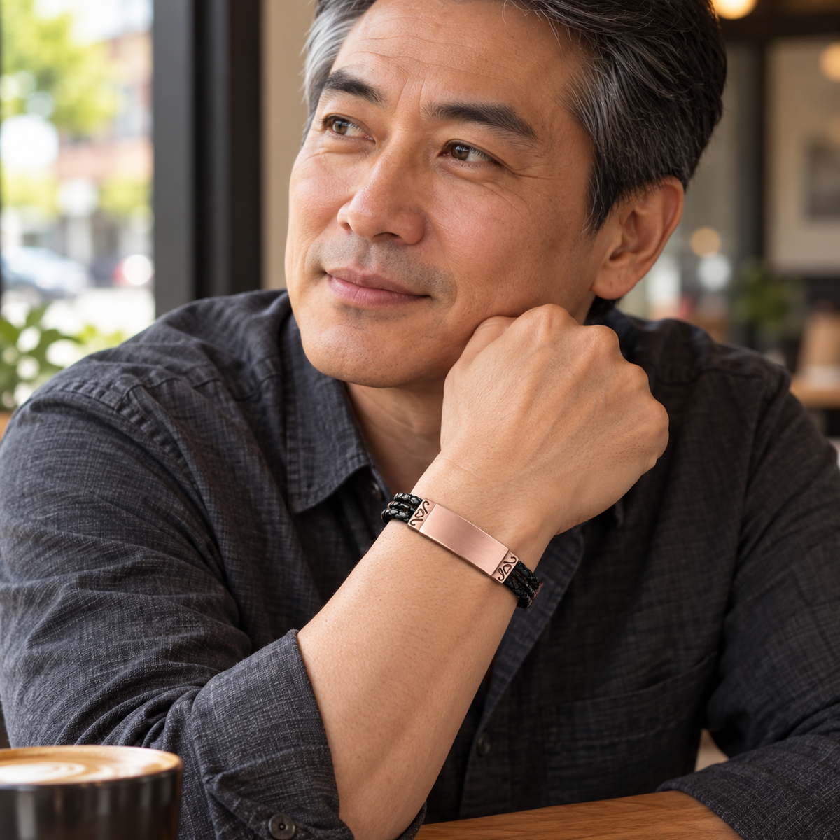 Rose gold plated cremation bracelet worn on a man's wrist