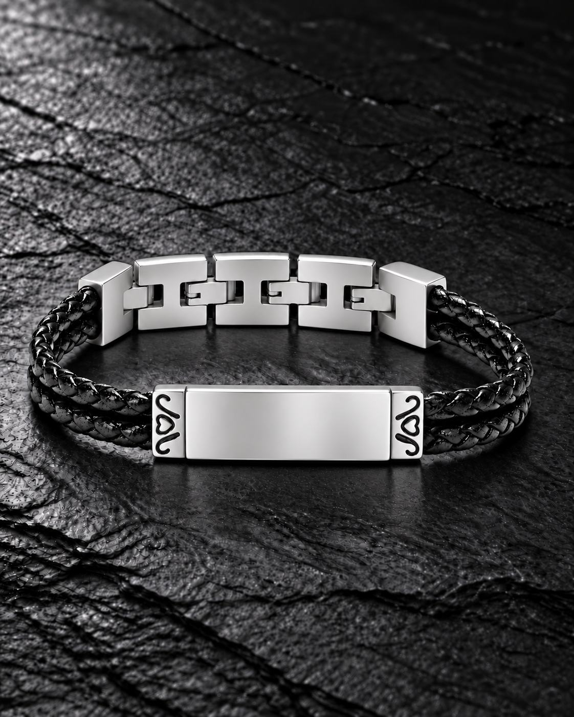 Polished silver cremation bracelet with level front plate and double black braided leather bands on dark stone