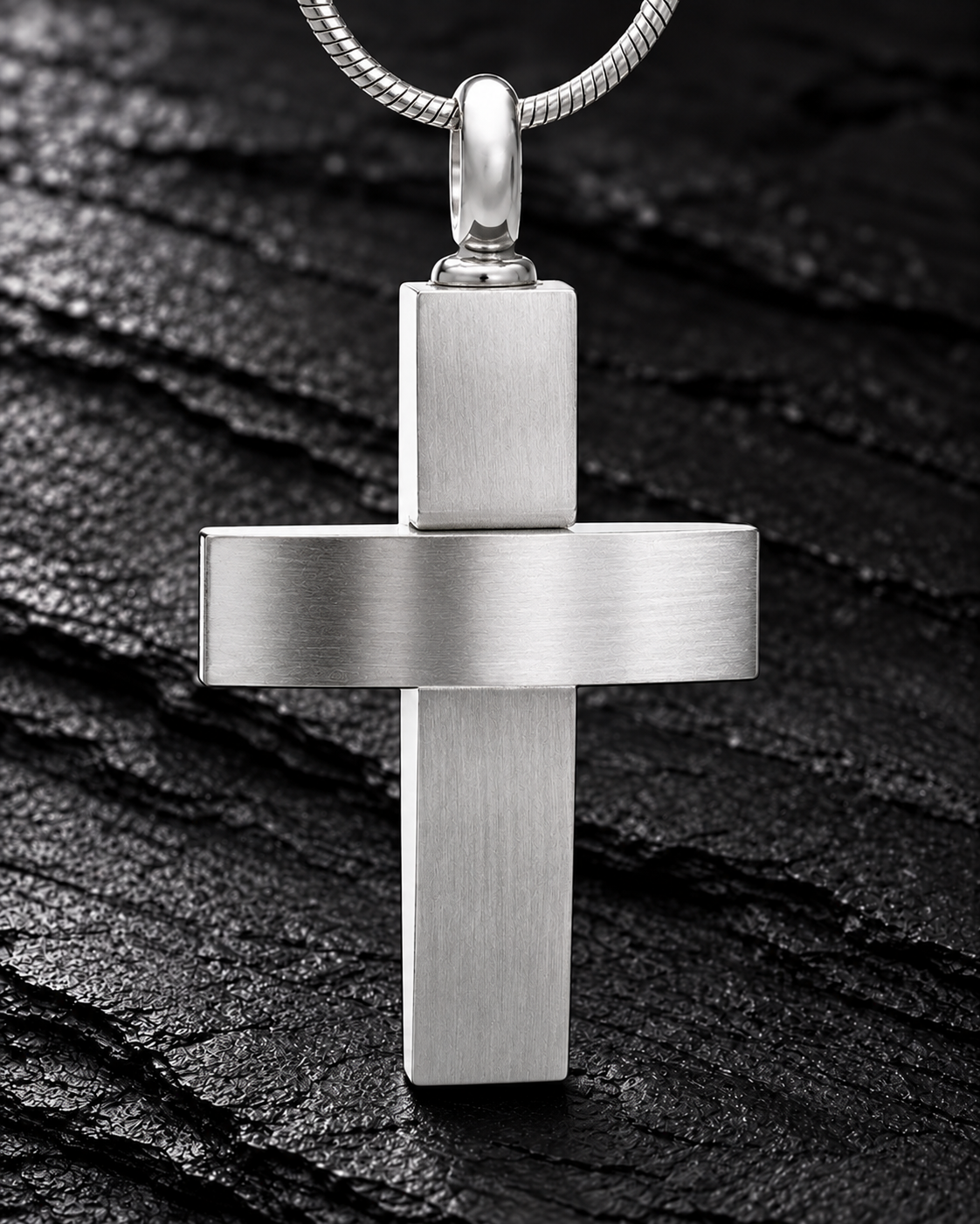 Silver stainless steel Modern Cross pendant with snake chain on charcoal slate
