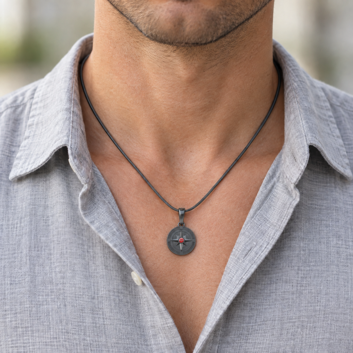 Black Compass Permanently Sealed pendant worn on its matching snake chain.