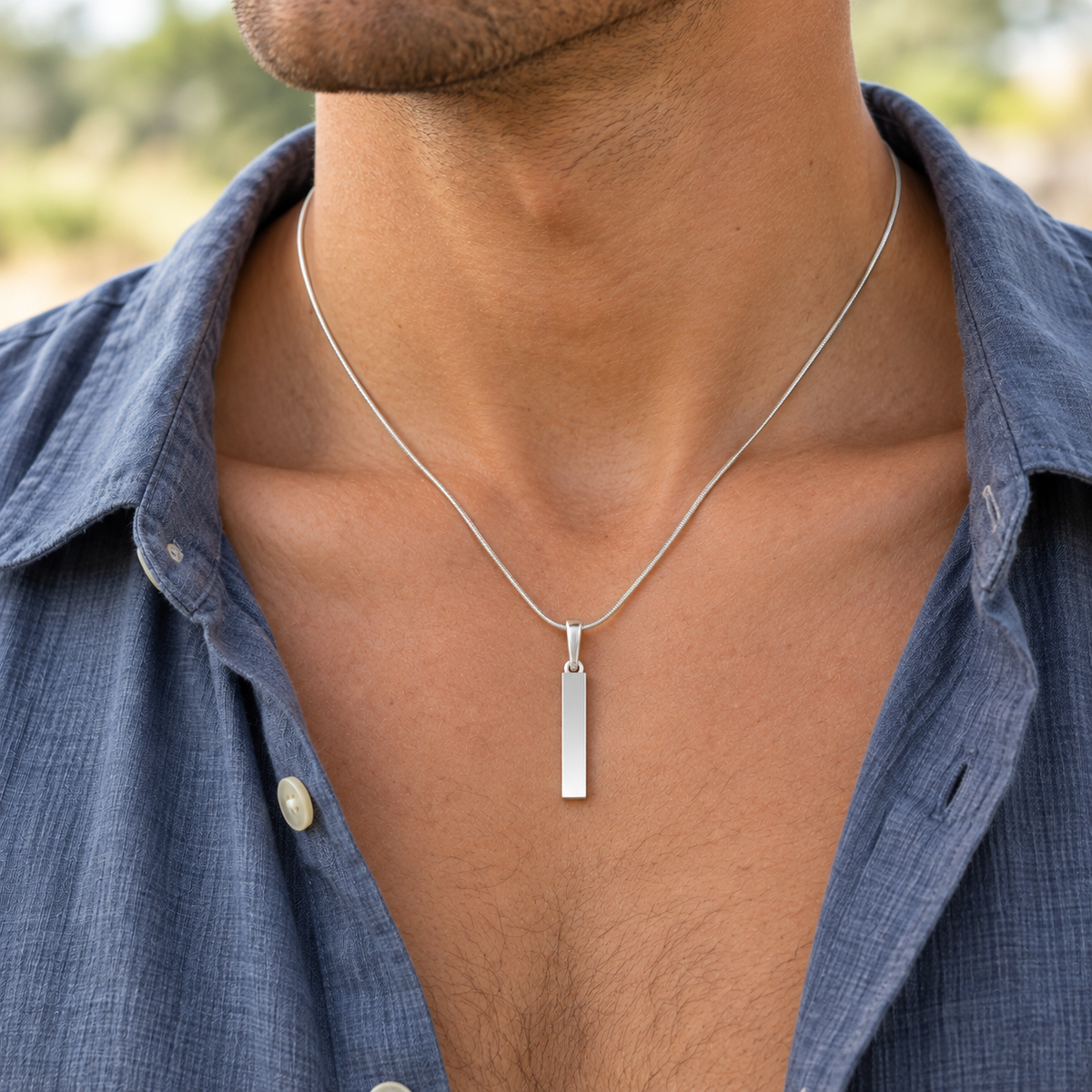 sterling silver Steadfast Long Cylinder keepsake pendant worn on an adult model