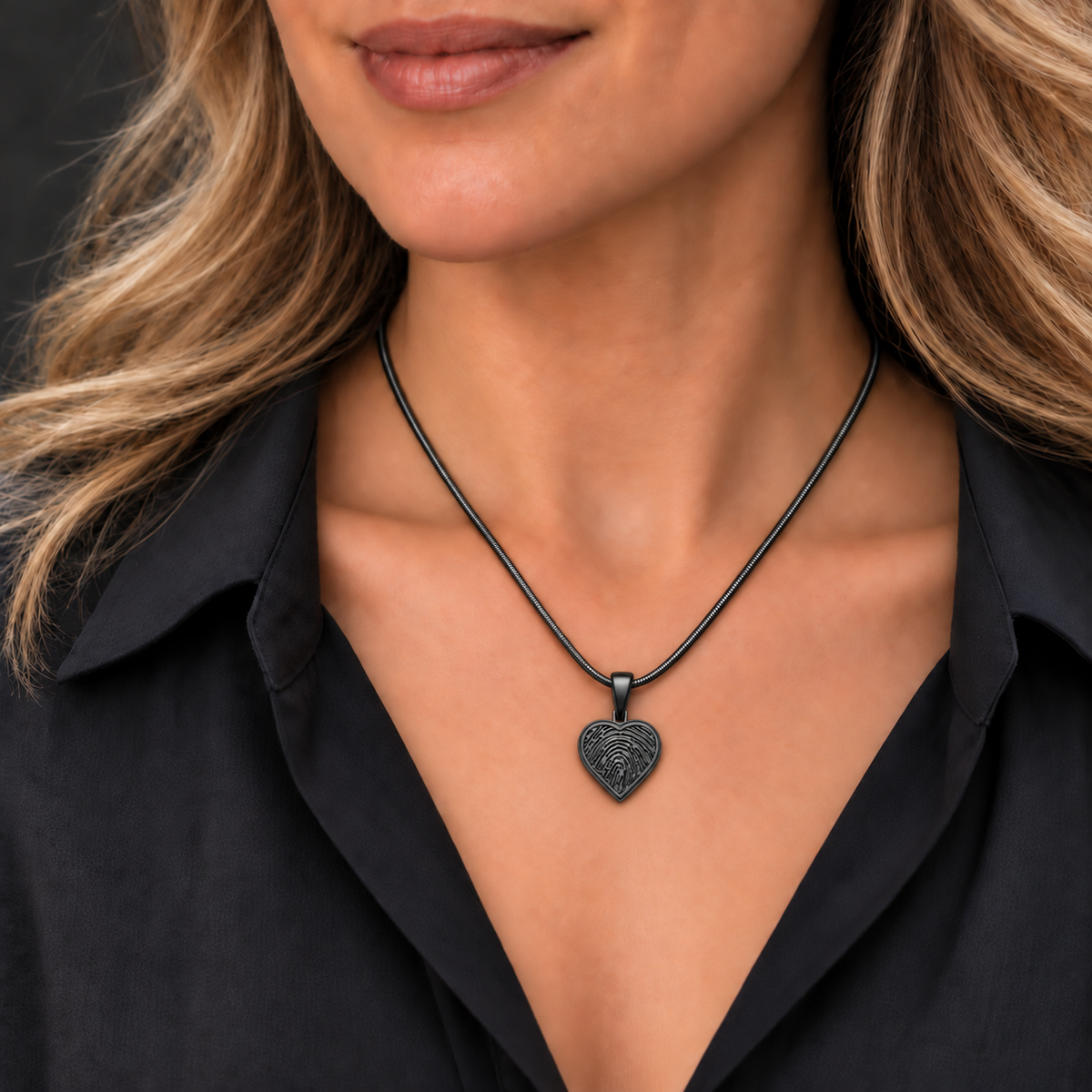 Black plated heart fingerprint pendant — worn with a matching snake chain