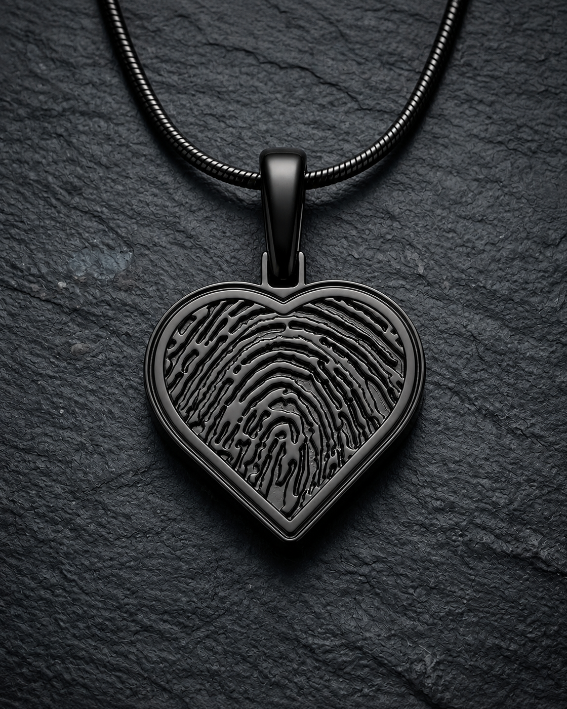 Black plated heart fingerprint pendant — on charcoal slate
