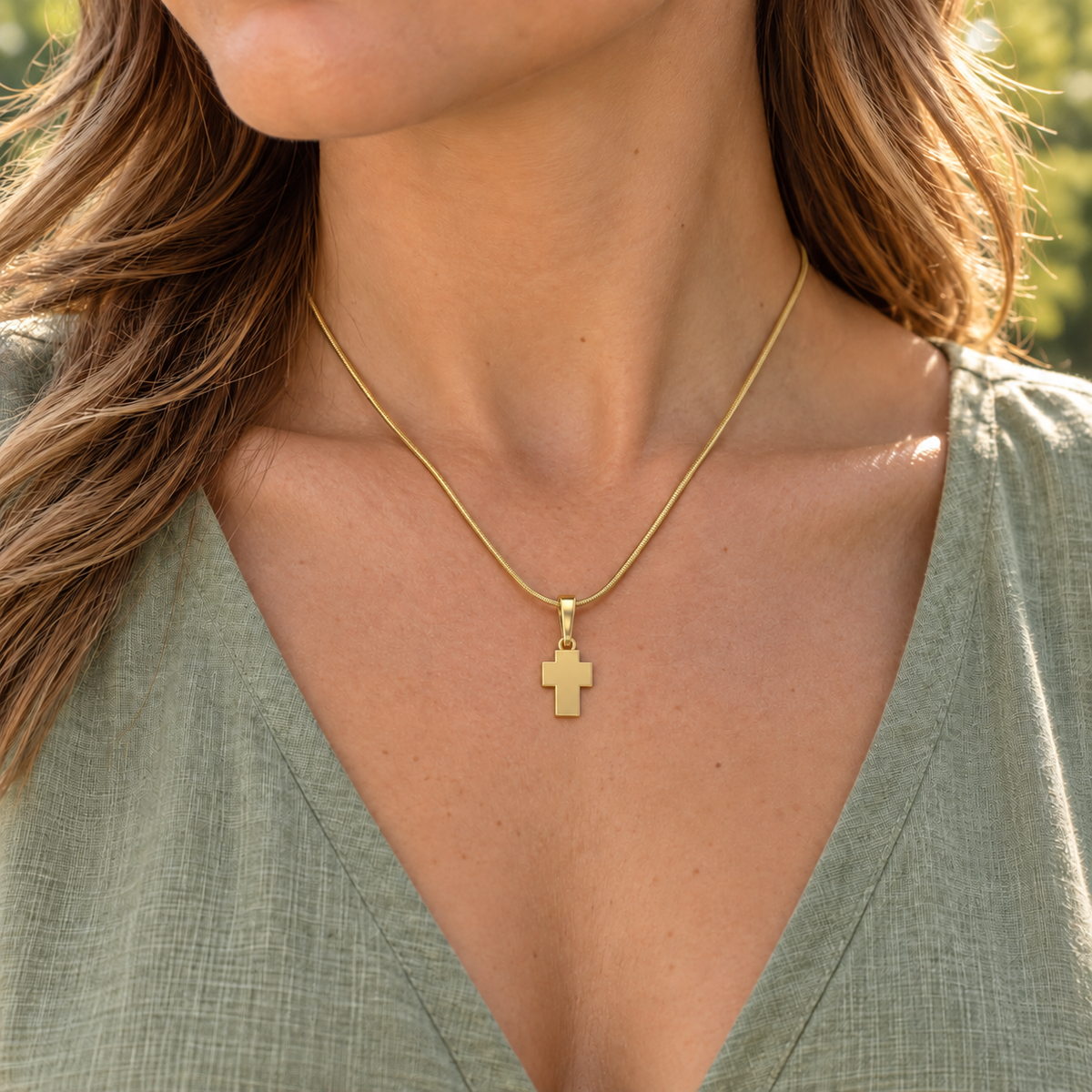 Gold Plated Blessed Cross Jewelry worn naturally at a discreet scale on a matching snake chain